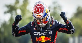 Max Verstappen celebrates victory after getting out of his car at Monza.