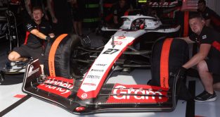 Haas driver Nico Hulkenberg with the tyre warmers on his VF-23 as he waits to leave the garage.