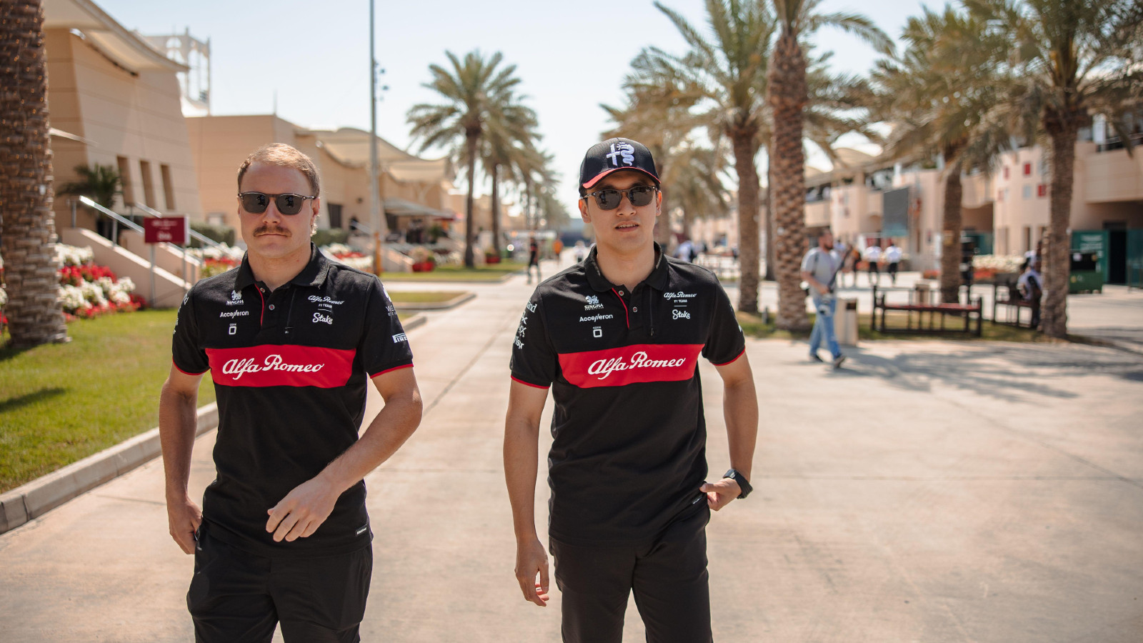 Alfa Romeo's Valtteri Bottas and Zhou Guanyu in the F1 paddock in early 2023.