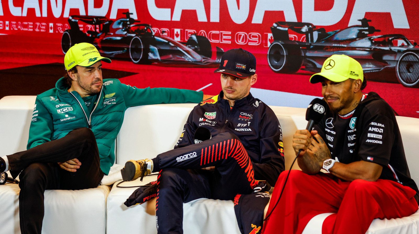 Fernando Alonso, Max Verstappen and Lewis Hamilton speaking during a press conference.