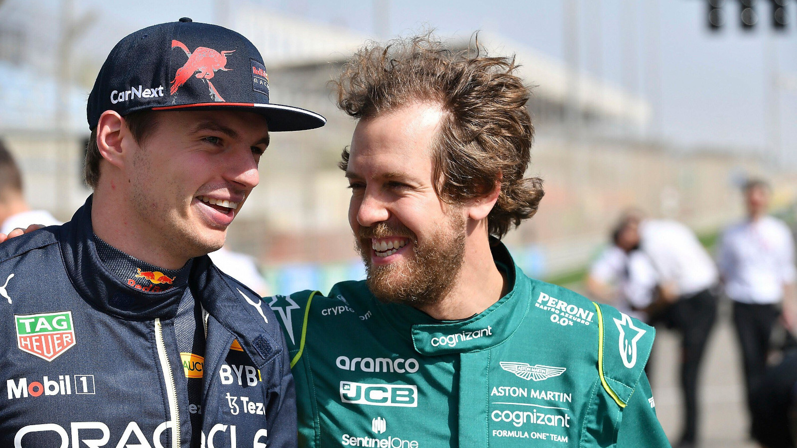 Sebastian Vettel with his arm around Max Verstappen in the pre 2022 group grid event.