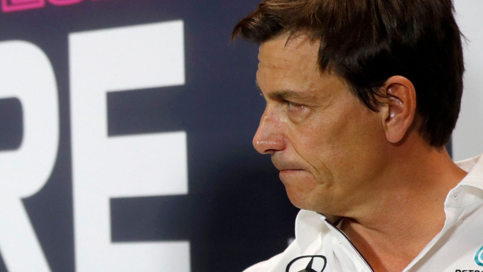 Mercedes motorsport boss Toto Wolff with his lips pursed looking stern.