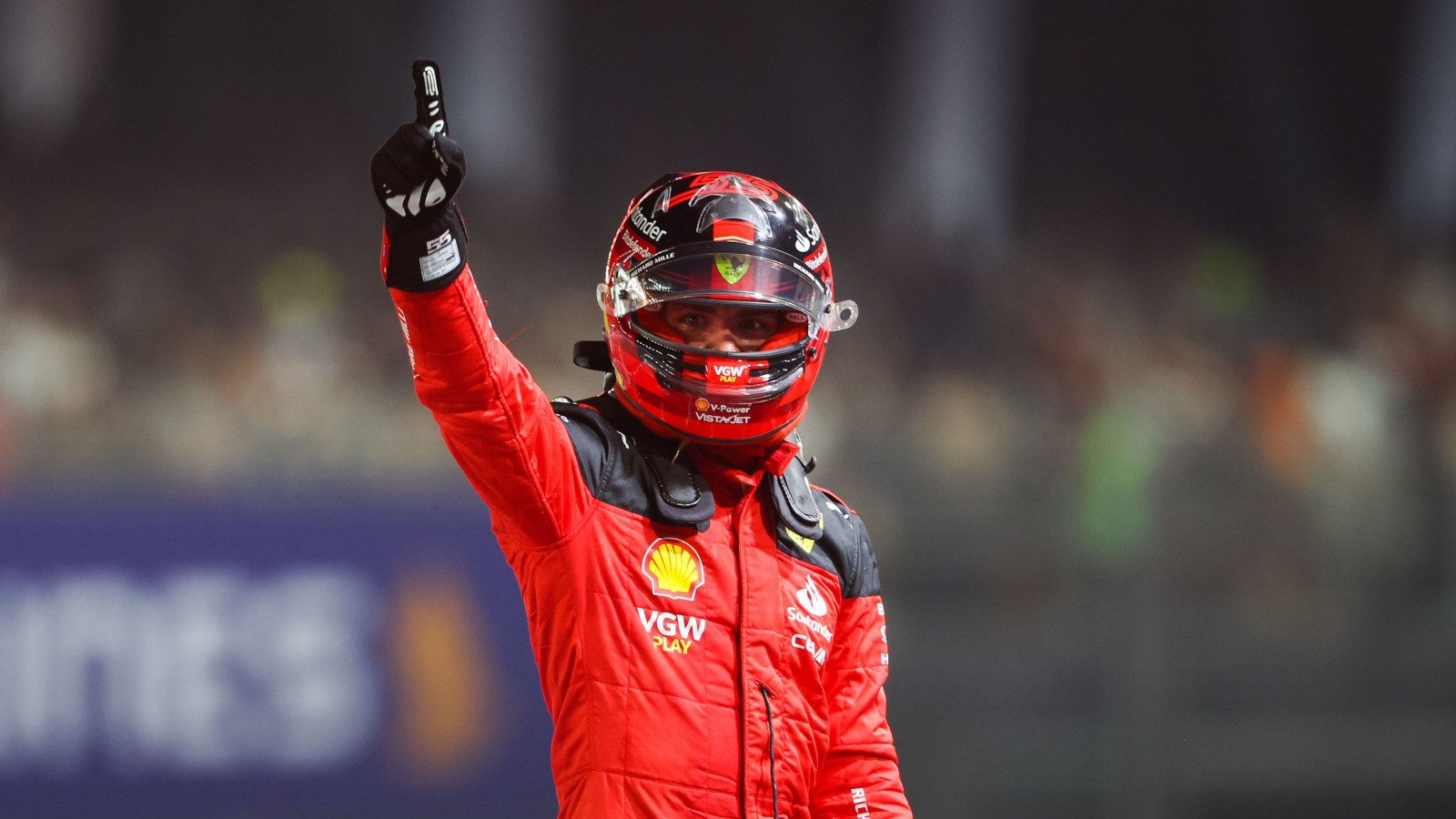 Ferrari driver Carlos Sainz finger raised in celebration.