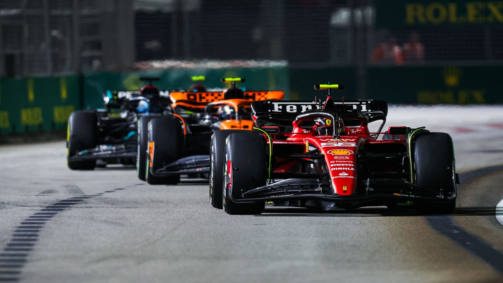 Ferrari driver Carlos Sainz holding off Lando Norris, George Russell and Lewis Hamilton in Singapore.