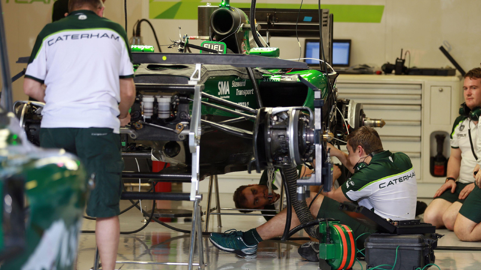 Caterham mechanics work in the garage at the 2014 Abu Dhabi Grand Prix.