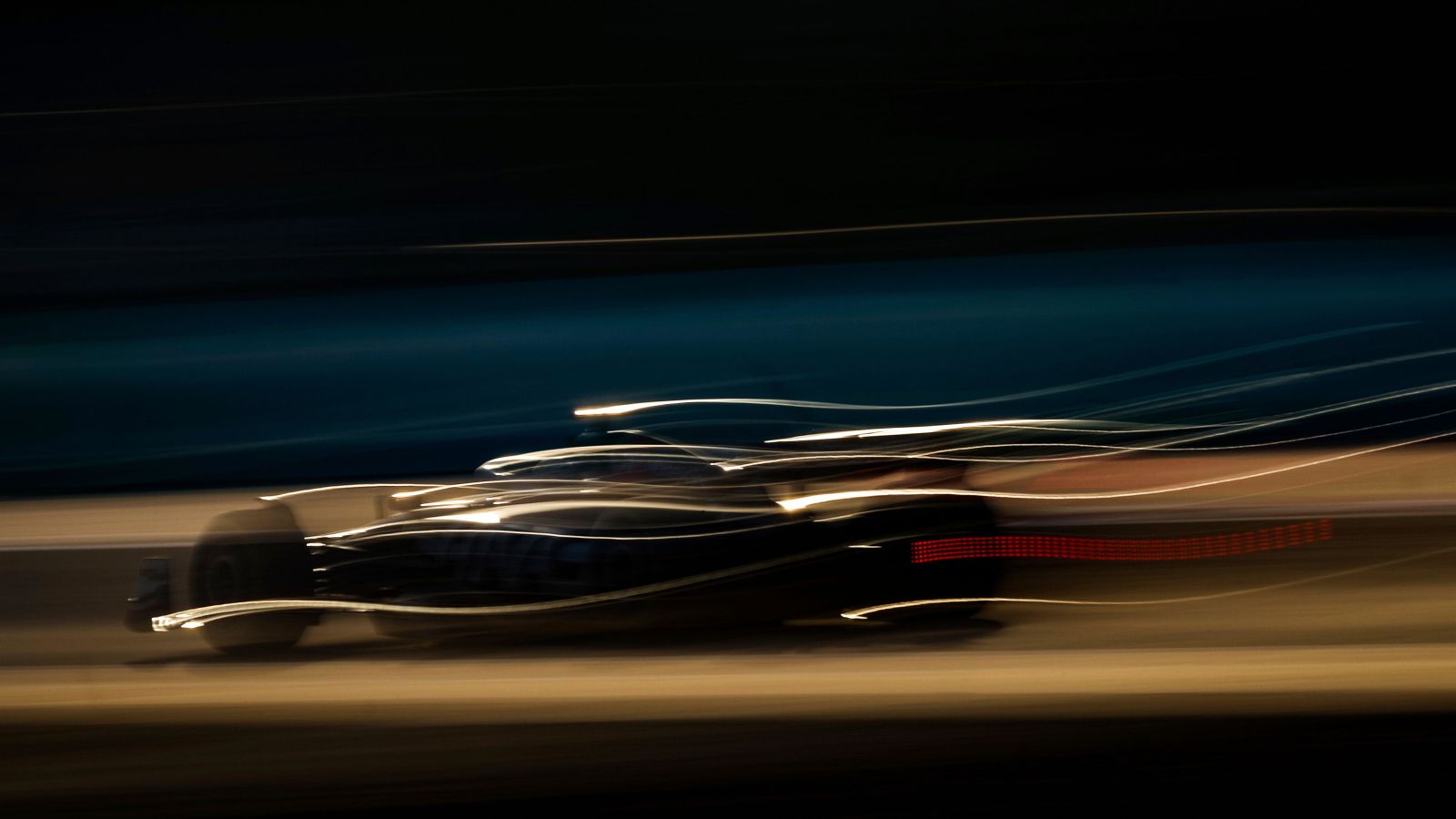 A blurry shot of Kevin Magnussen, Haas, moving at speed during F1 2024 pre-season testing in Bahrain