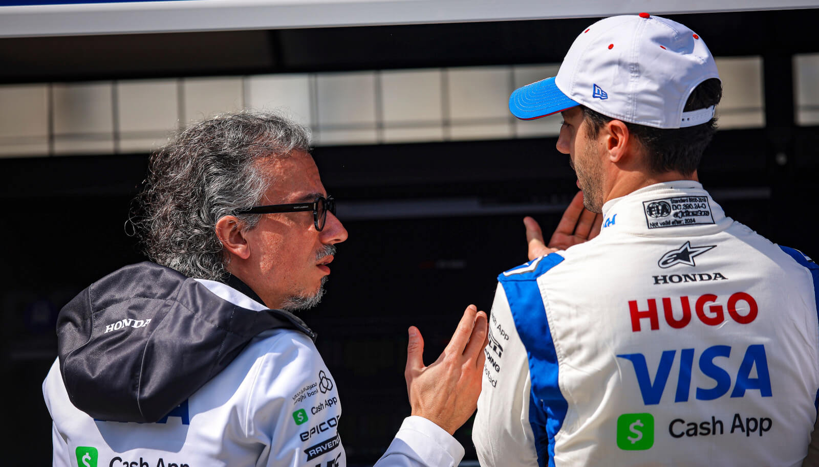 Daniel Ricciardo speaking with team boss Laurent Mekies.