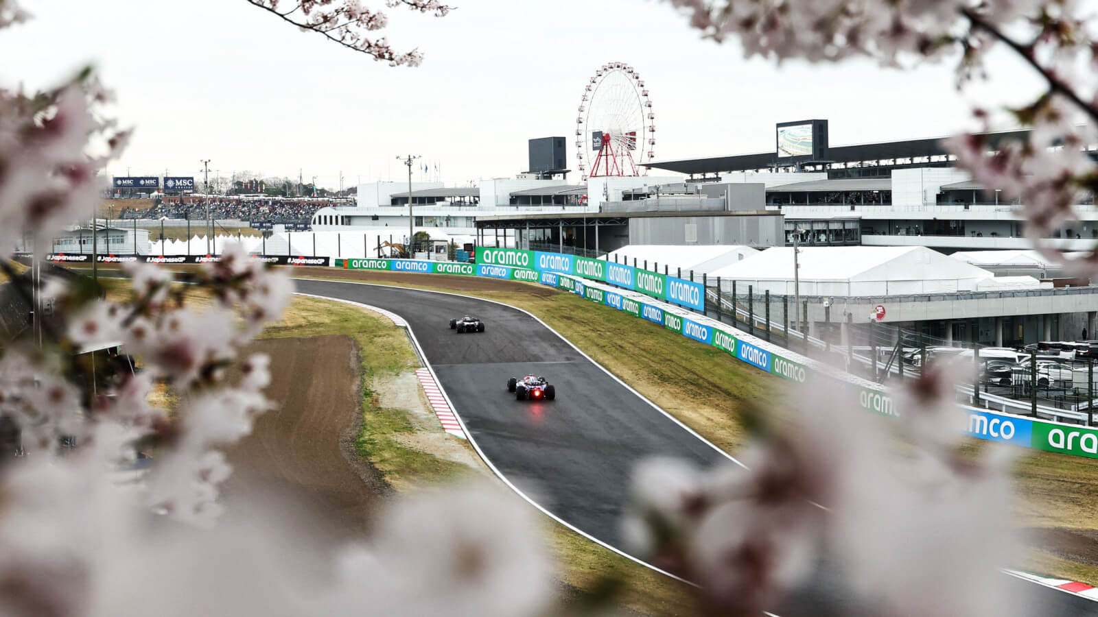 F1 cars battling through Suzuka S-Curves during Japanese Grand Prix
