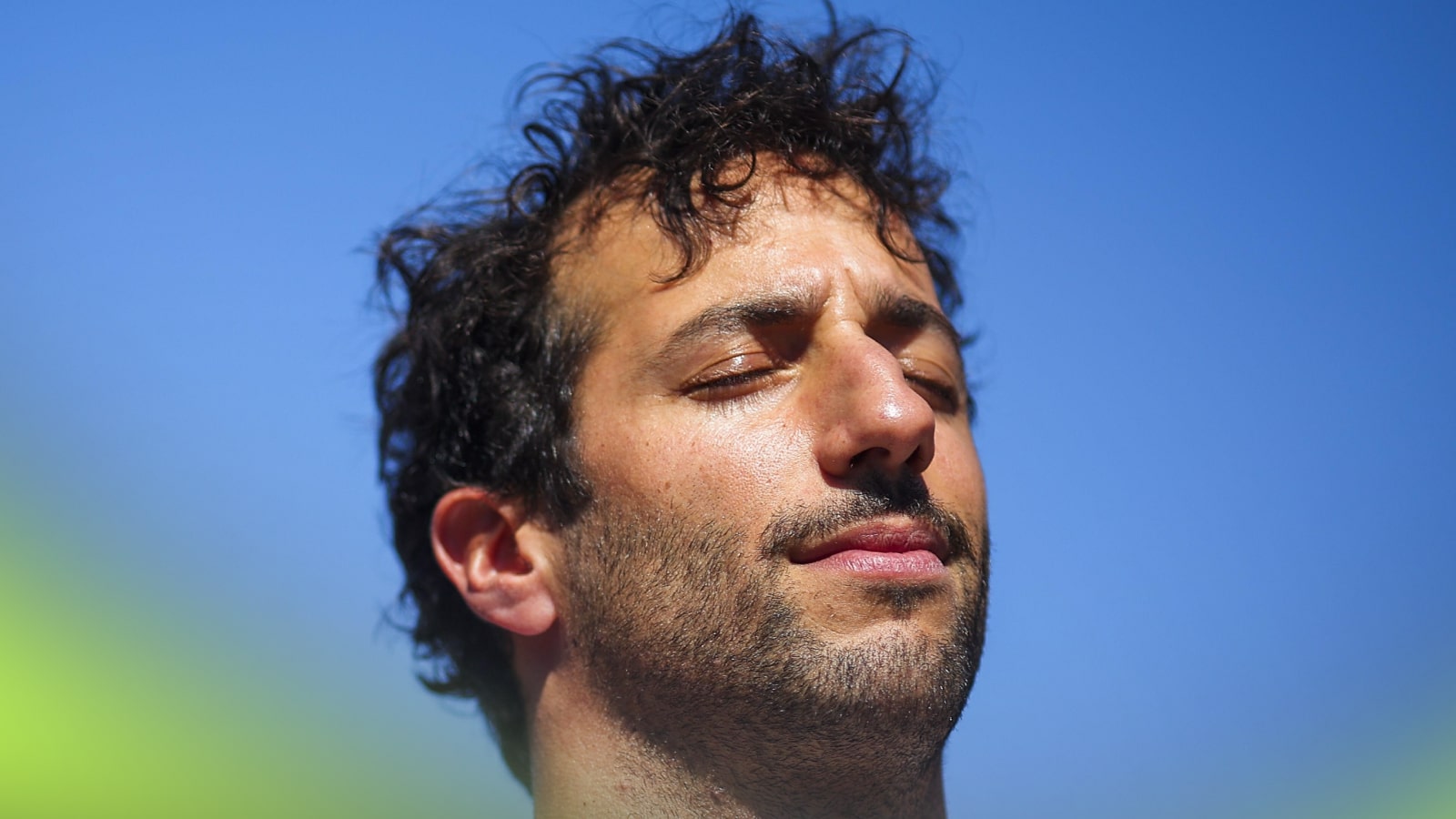 Daniel Ricciardo shuts his eyes during the national anthem at the 2024 Australian Grand Prix