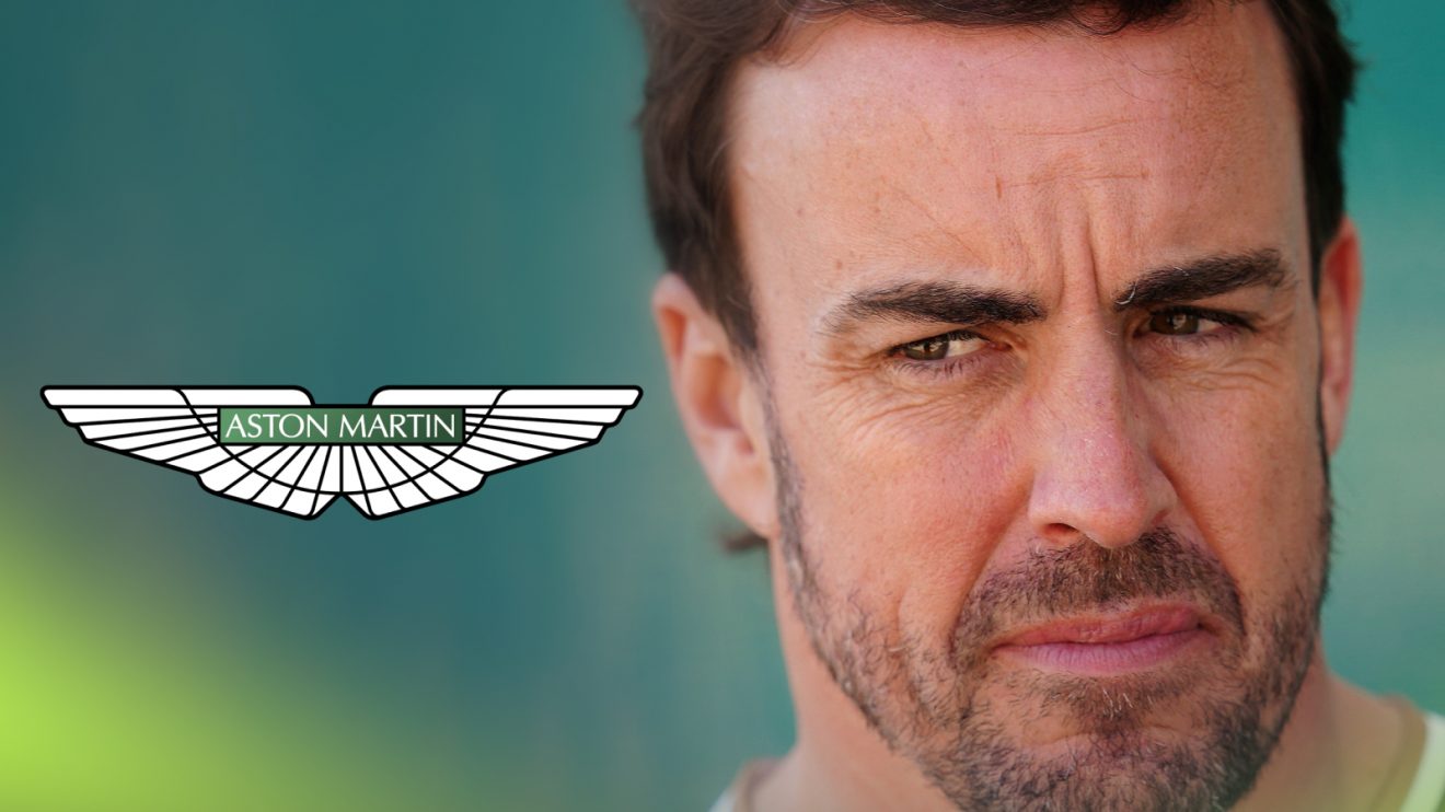 Fernando Alonso glances to his right where a prominent Aston Martin logo sits alongside him