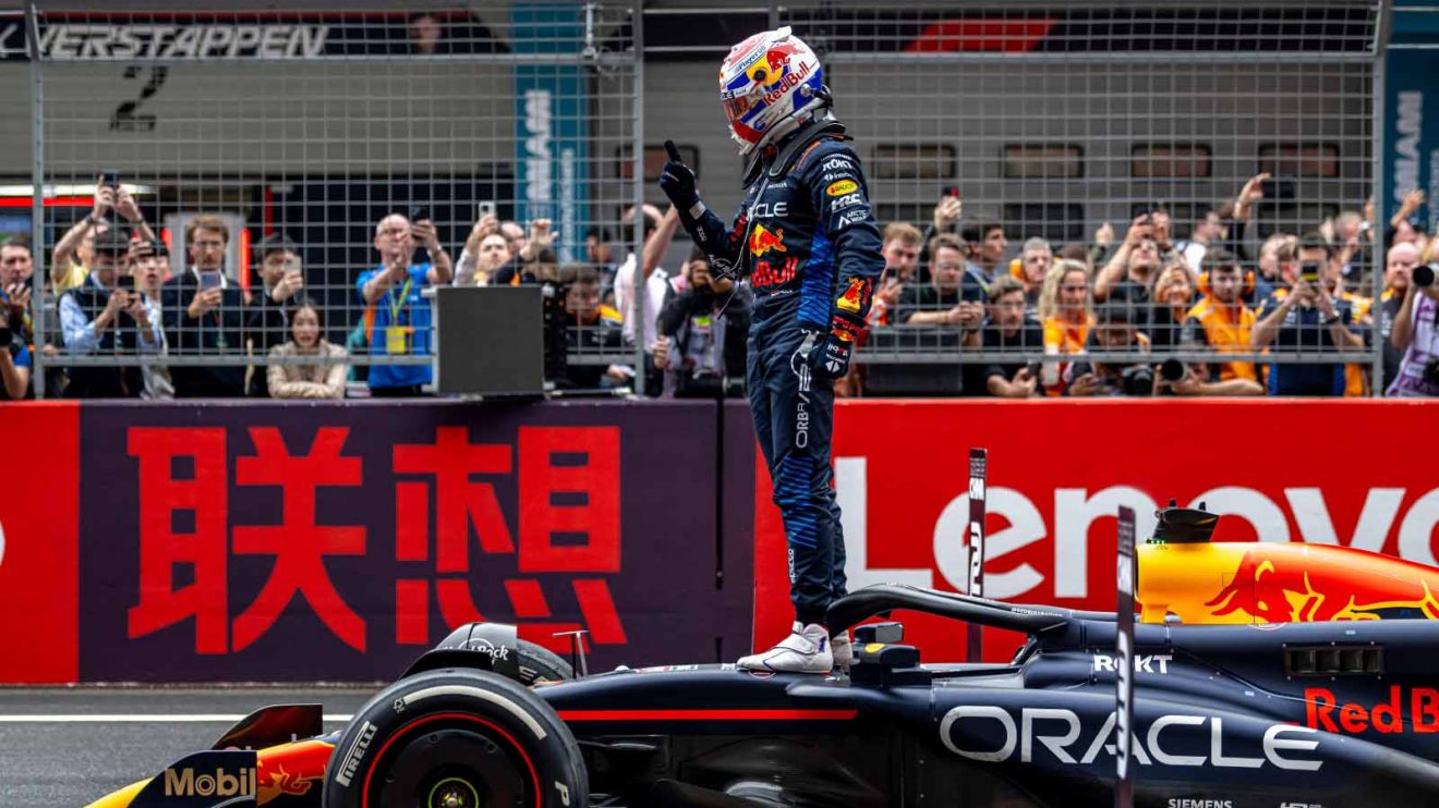 Max Verstappen on top of his car.