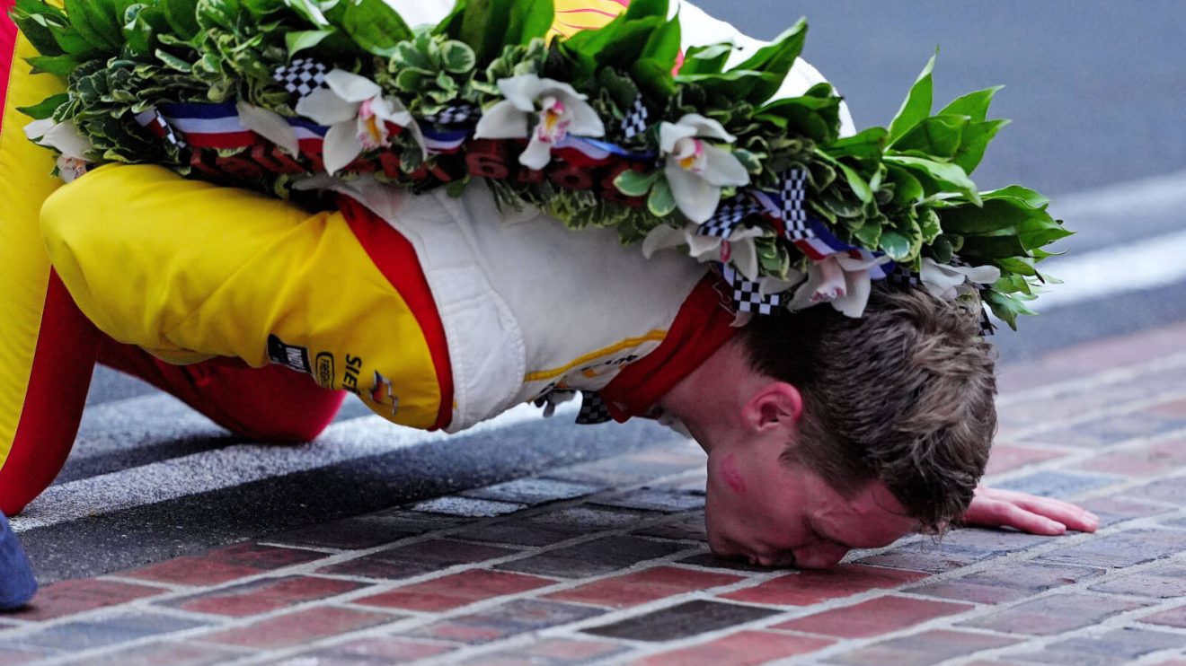 Josef Newgarden kisses the bricks