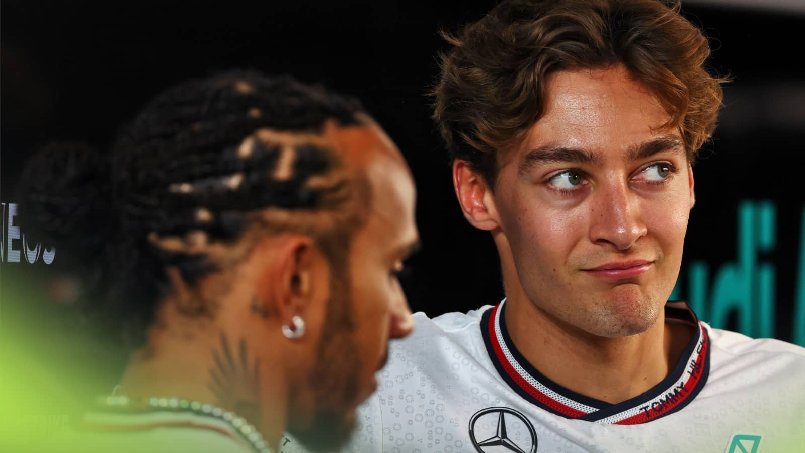 George Russell looks unimpressed in conversation with Lewis Hamilton