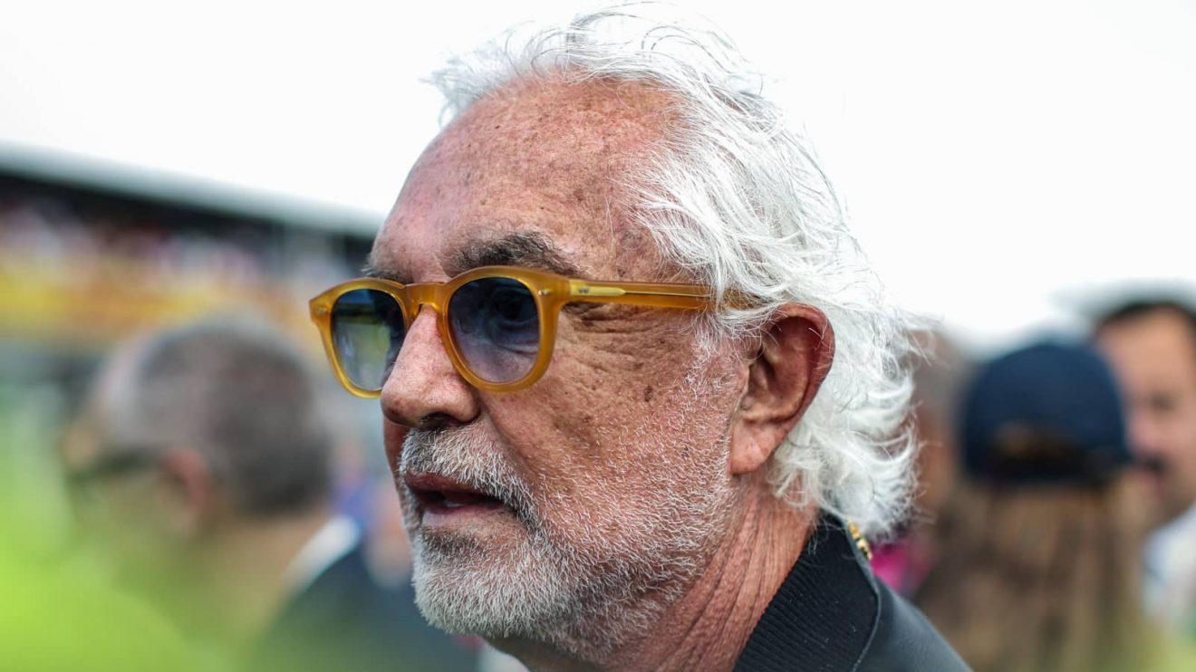 A close-up shot of Flavio Briatore on the grid at Imola