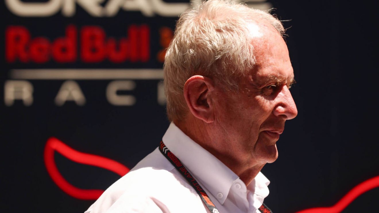 Helmut Marko walks past Red Bull Racing signage