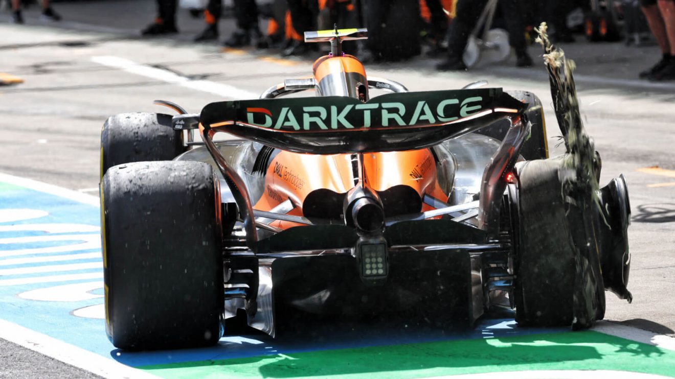 Lando Norris pulls into the pits with a rear right puncture