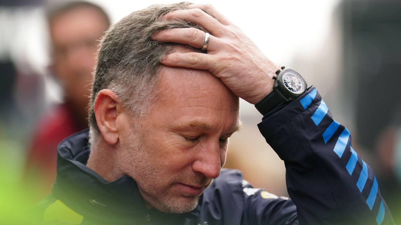 A downbeat Christian Horner holds his hand to his head