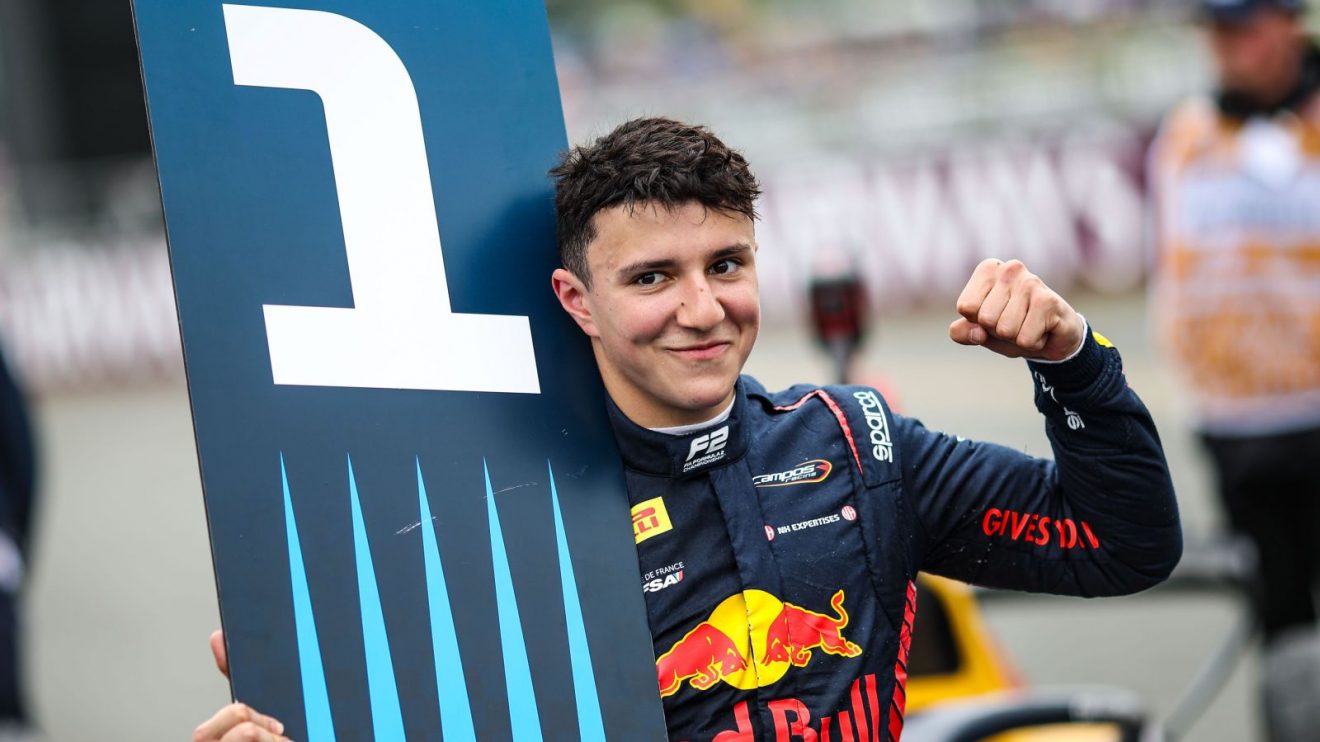 Red Bull junior Isack Hadjar holds the P1 board after winning the Silverstone F2 feature race.