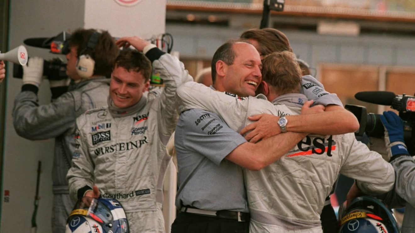 Ron Dennis hugs Mika Hakkinen, David Coulthard walks past