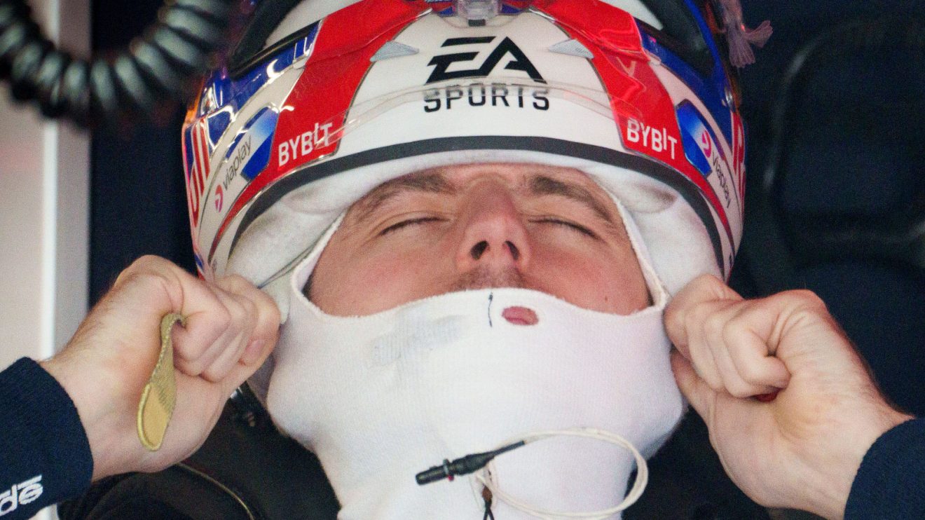 Max Verstappen pulls on his helmet