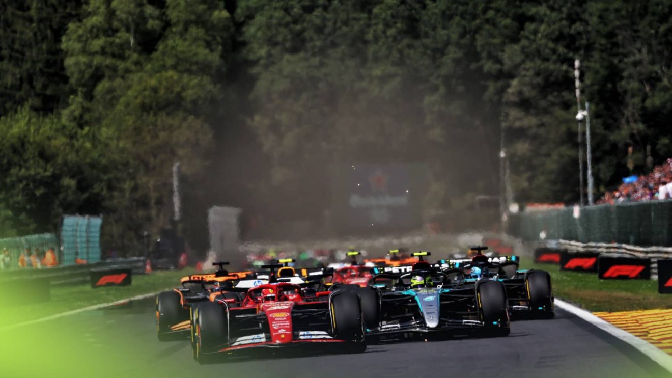 Charles Leclerc leads Lewis Hamilton as the cars at the end of the Kemmel straight at the start of the 2024 Belgian Grand Prix