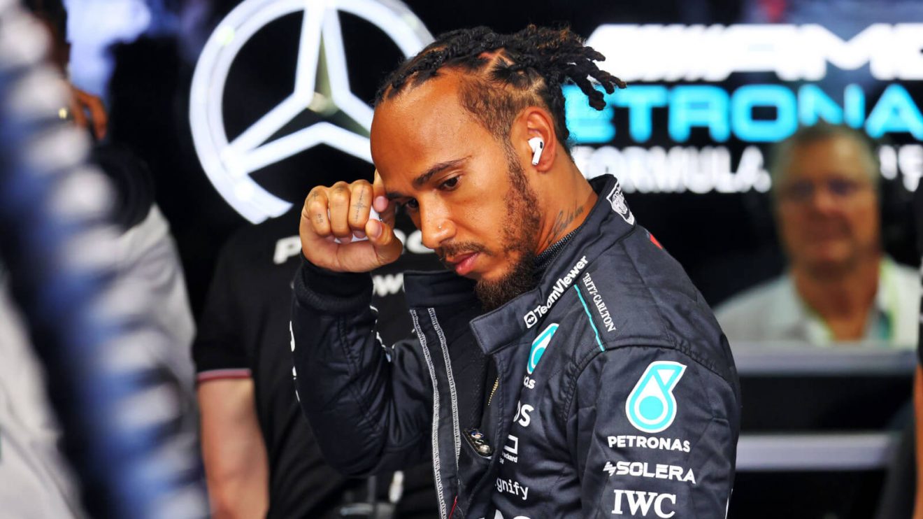 Lewis Hamilton in the Mercedes garage in front of the team's logo