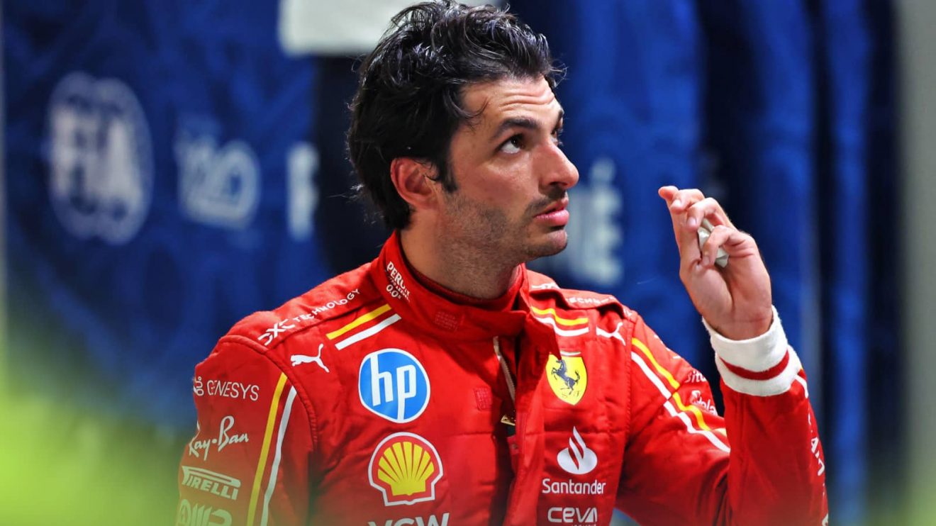 Carlos Sainz looks up as he returns to the pits after crashing out of qualifying in Singapore
