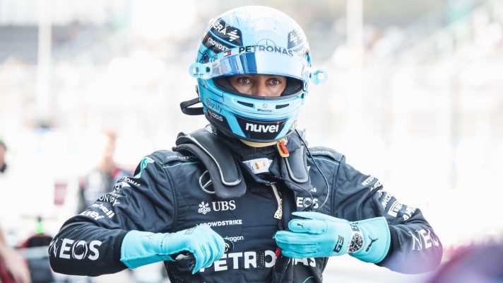 George Russell removes his gloves