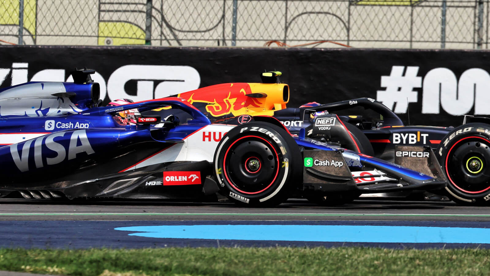 Liam Lawson wheel to wheel with Sergio Perez