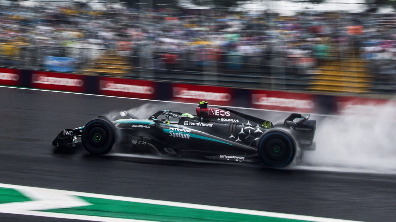 Lewis Hamilton driving in the wet, spray coming up from his W15