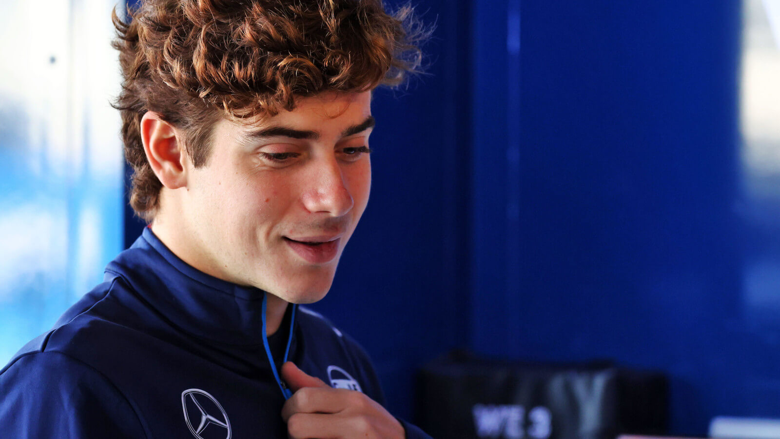 Franco Colapinto smiling in the Williams garage