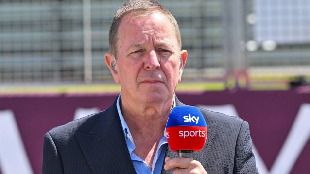 Sky F1 pundit and co-commentator Martin Brundle holding a Sky Sports microphone at the 2024 British Grand Prix.