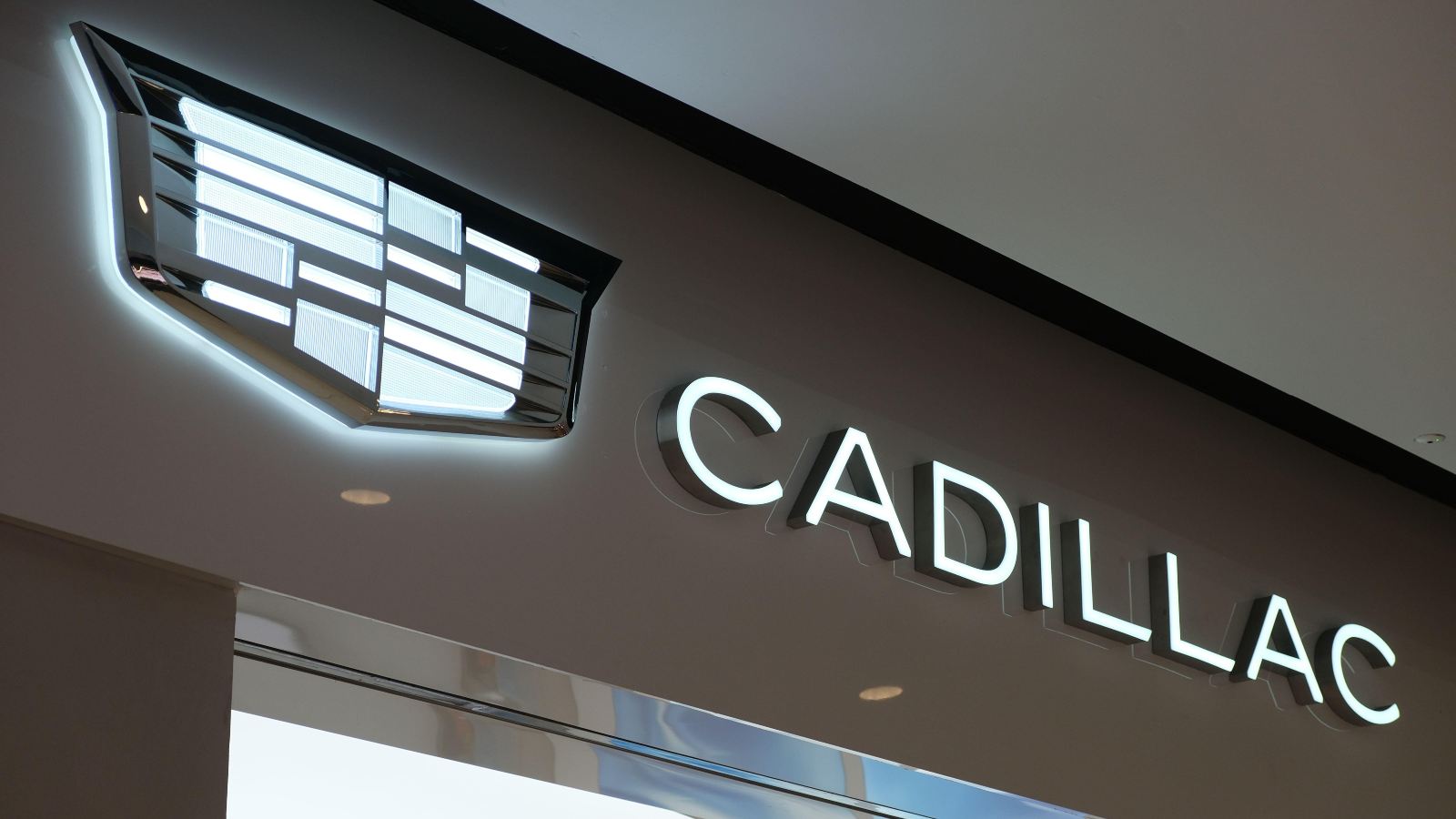 A diagonal Cadillac logo displayed.