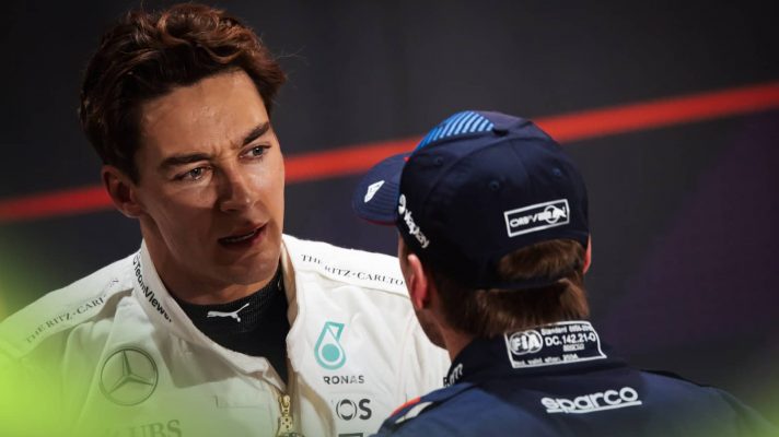George Russell looks stern in conversation with Max Verstappen in parc ferme