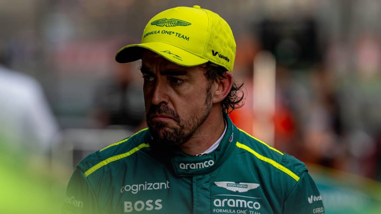 Fernando Alonso looks glum in the pit lane