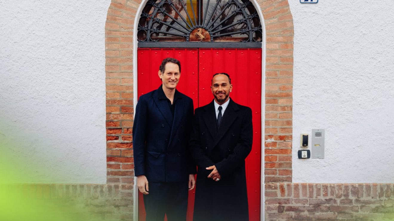 John Elkann and Lewis Hamilton pose outside the front door of Enzo Ferrari's house at Fiorano