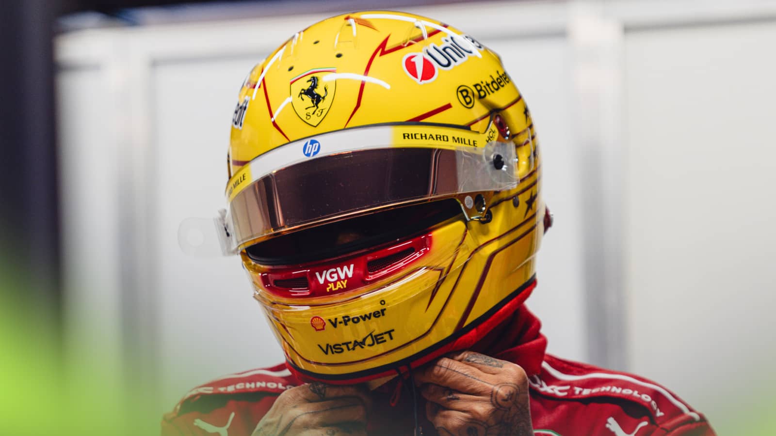 Lewis Hamilton fastens his helmet in the Ferrari garage in Barcelona