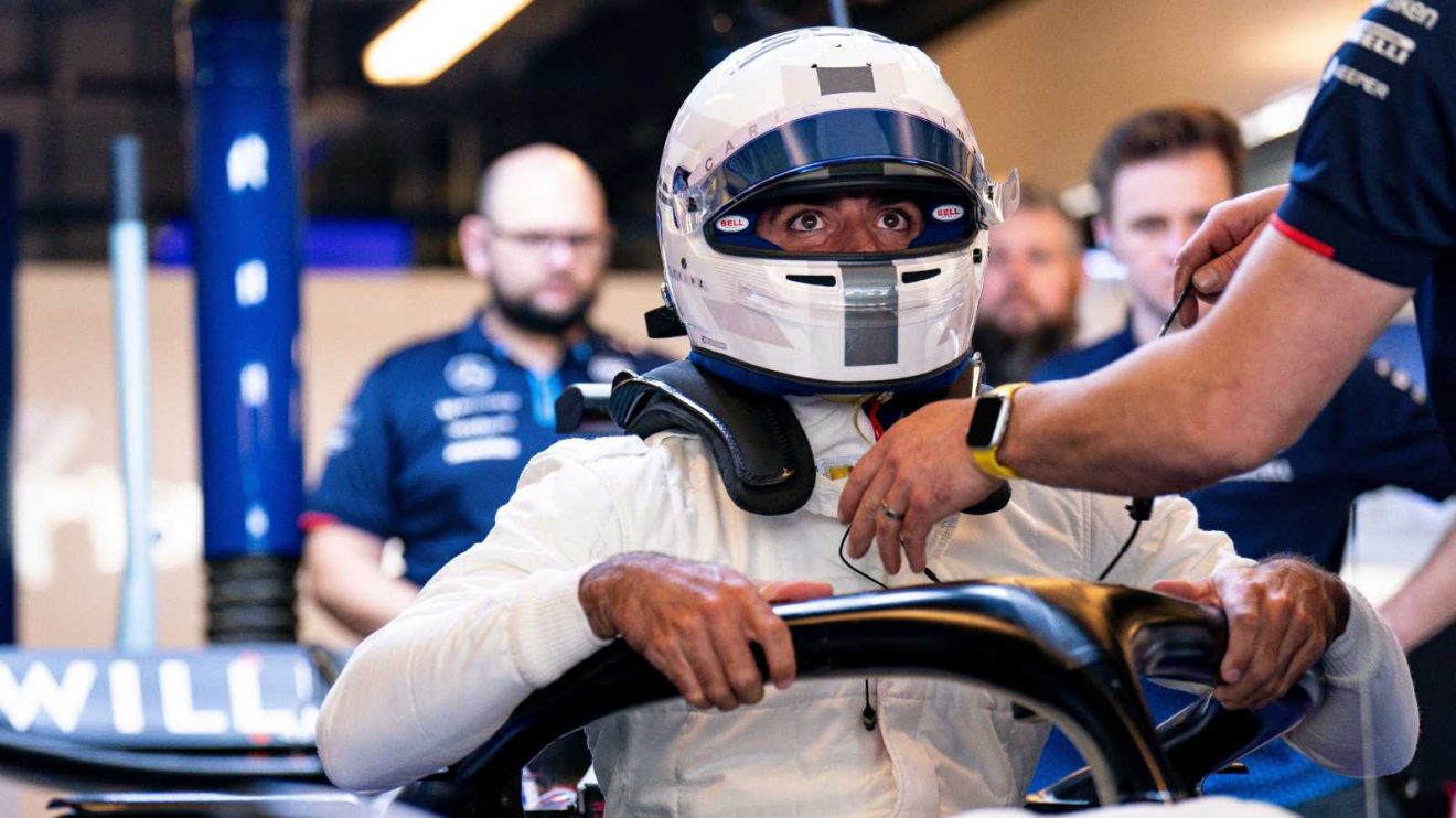 Carlos Sainz enters the Williams cockpit in Abu Dhabi.