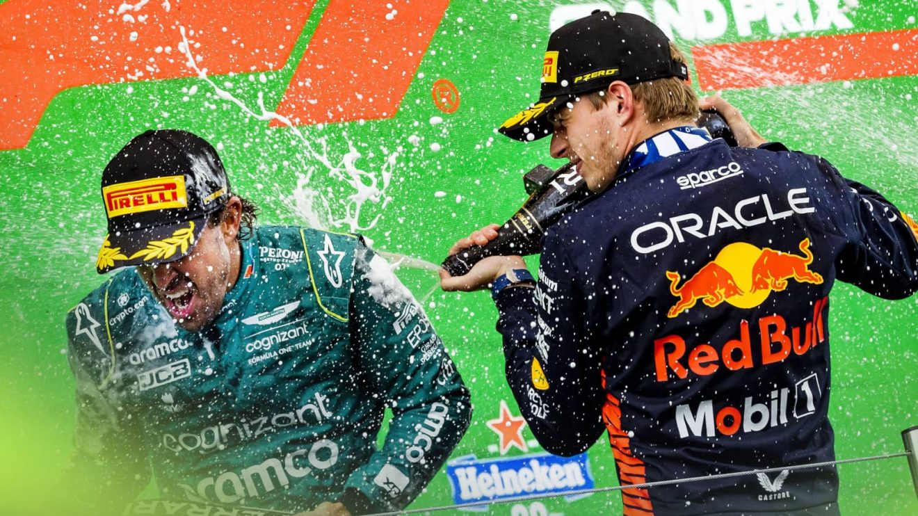 Fernando Alonso and Max Verstappen spray champagne on the podium