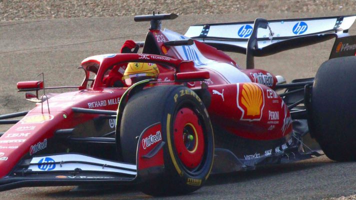 Lewis Hamilton waves at fans as he drives the Ferrari SF-25