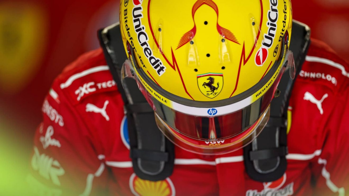 Lewis Hamilton lowers his head to reveal the top surface of his yellow Ferrari helmet