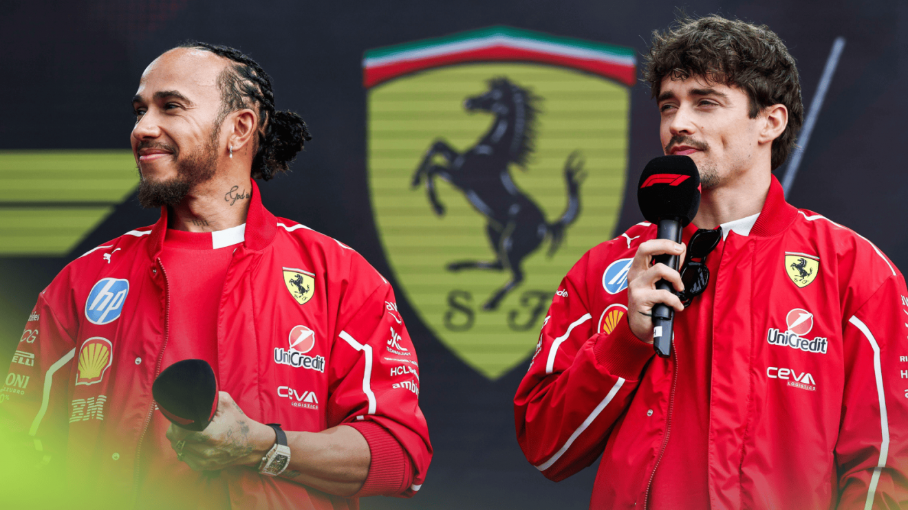 Lewis Hamilton and Charles Leclerc holding microphones on stage with a giant Ferrari logo in the background
