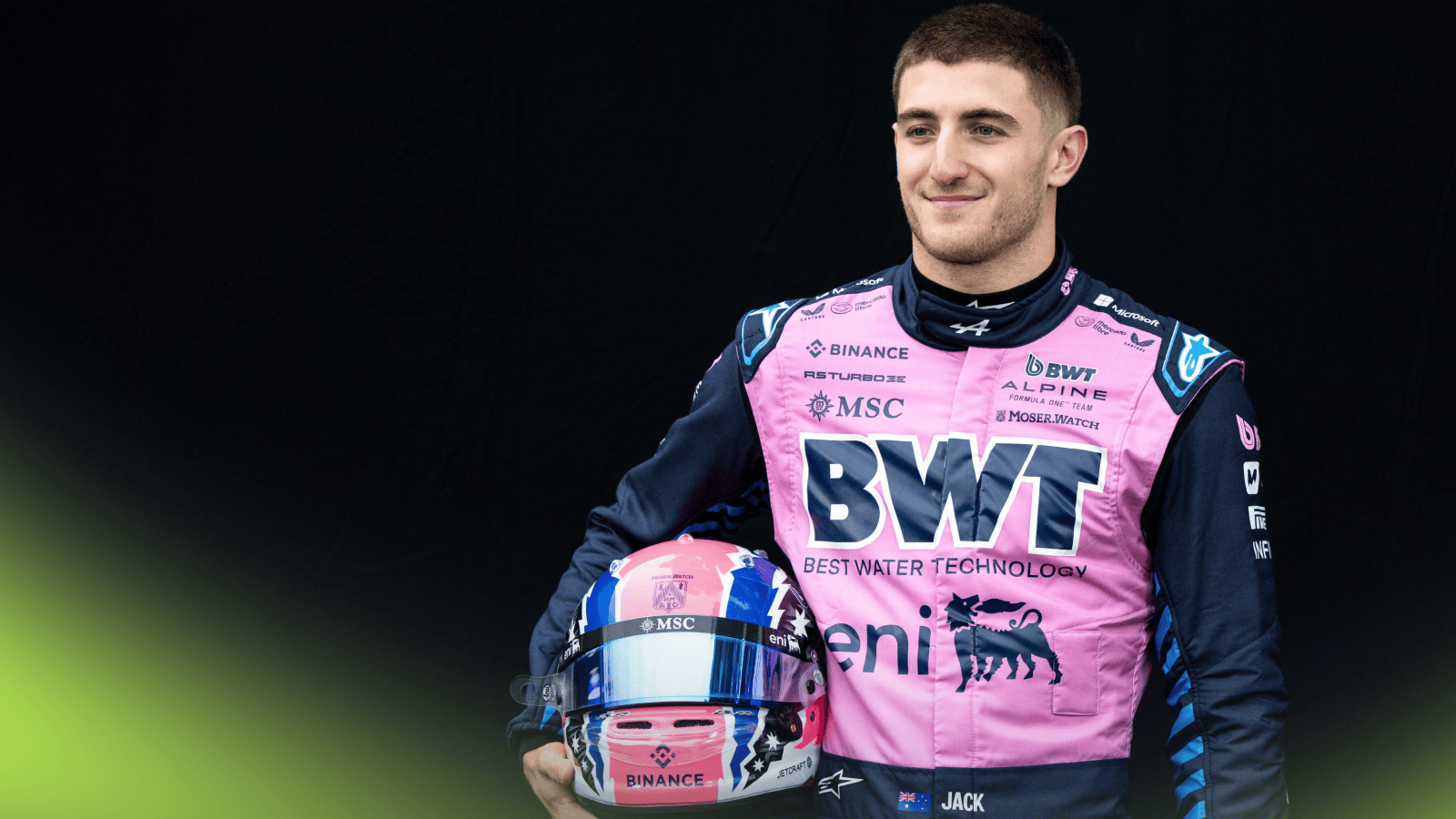 Jack Doohan smiles as he holds his helmet while posing for a portrait shot in Melbourne