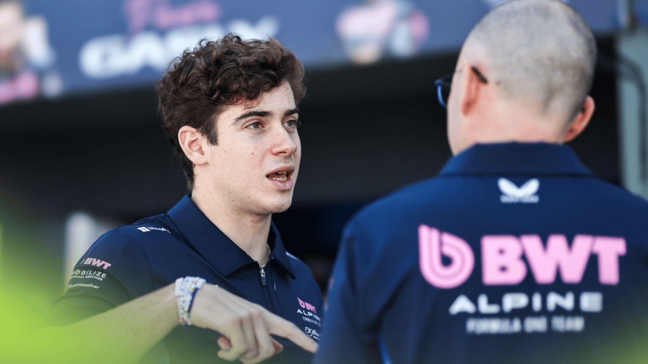 Franco Colapinto in conversation with an Alpine engineer in the Australian GP pit lane