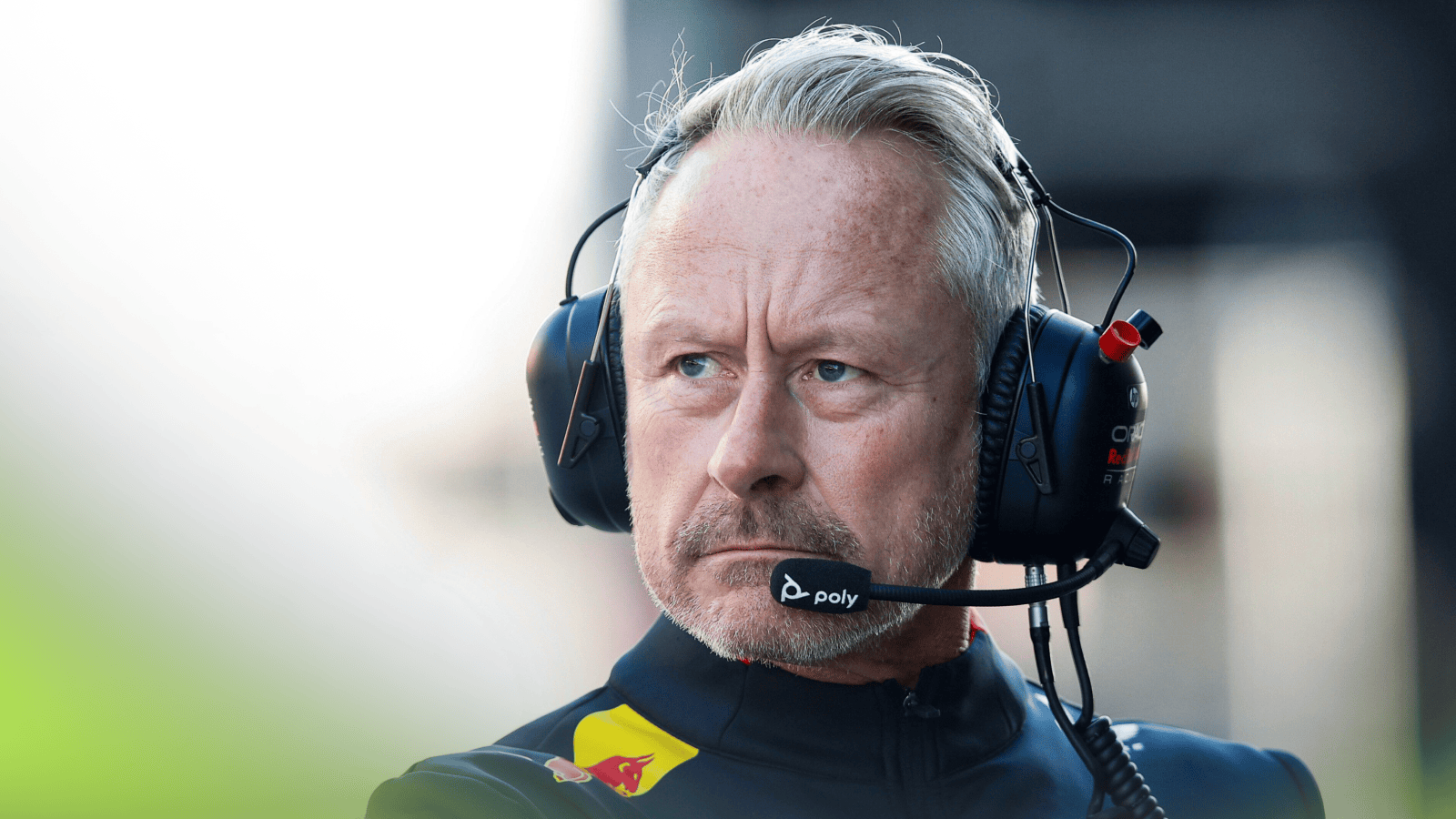 Jonthan Wheatley looks on in the pit lane as he wears headphones during his Red Bull career
