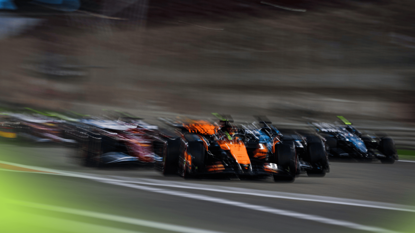 A dramatic and blurry shot of the start of the Bahrain GP with Oscar Piastri's McLaren in front