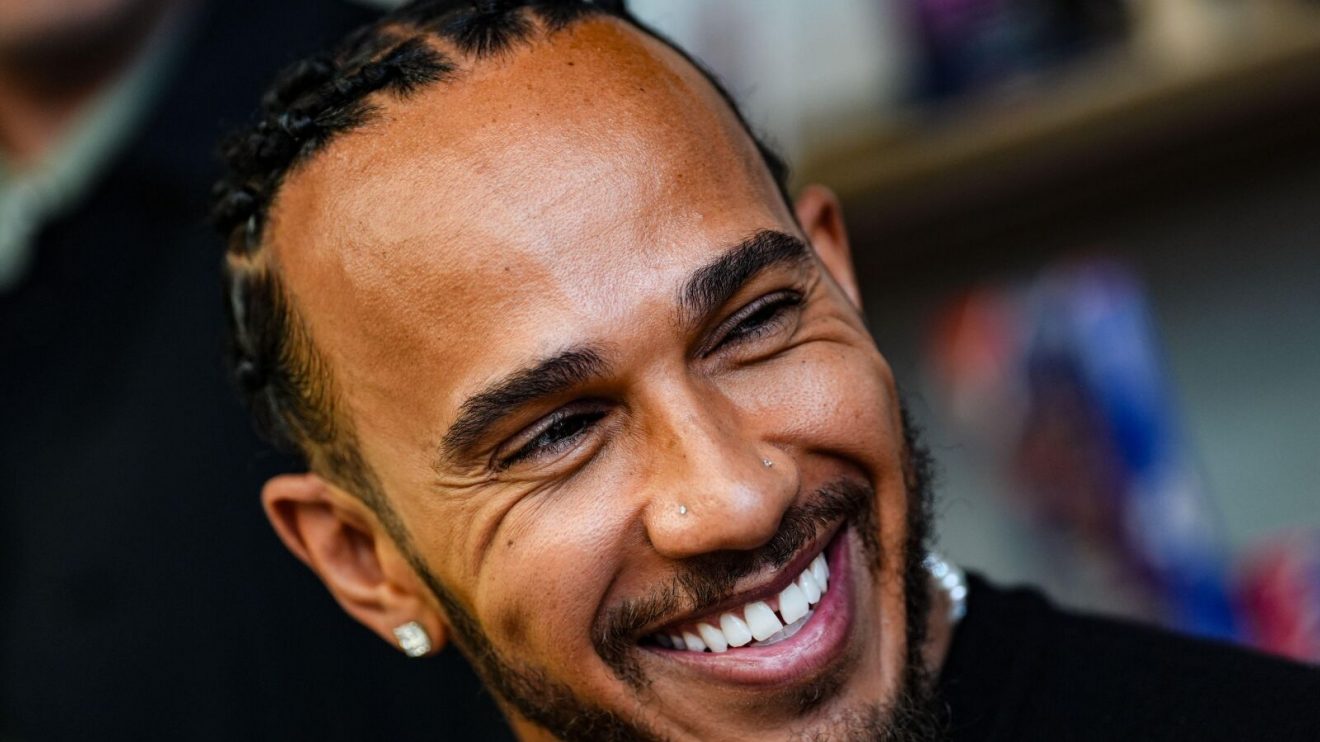 A smiling Lewis Hamilton at the launch of the first Fanatics Collectibles flagship store in London