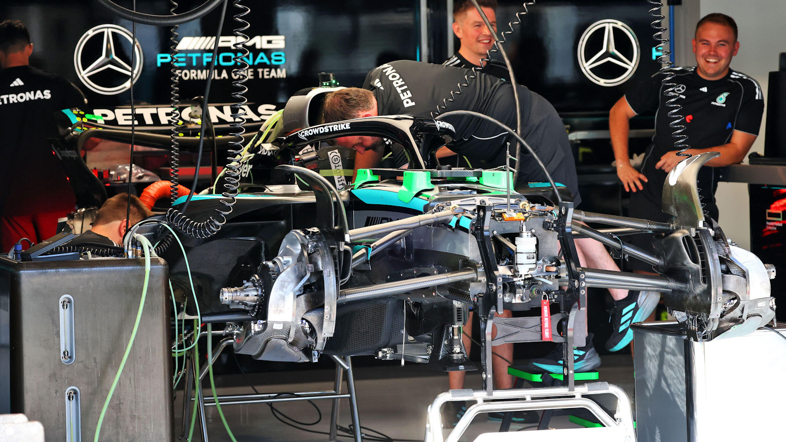 Mercedes mechanics prepare one of the W16's for action
