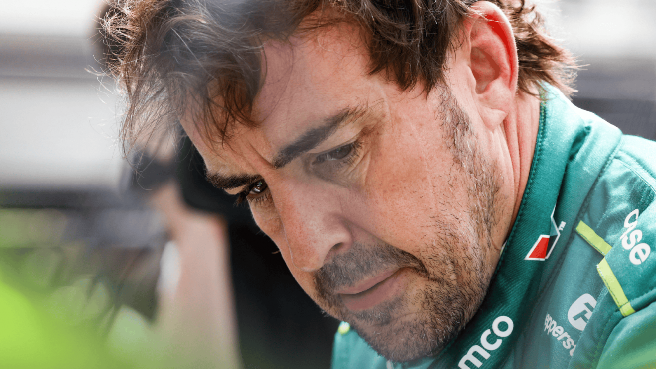 A close-up shot of Fernando Alonso looking deep in thought