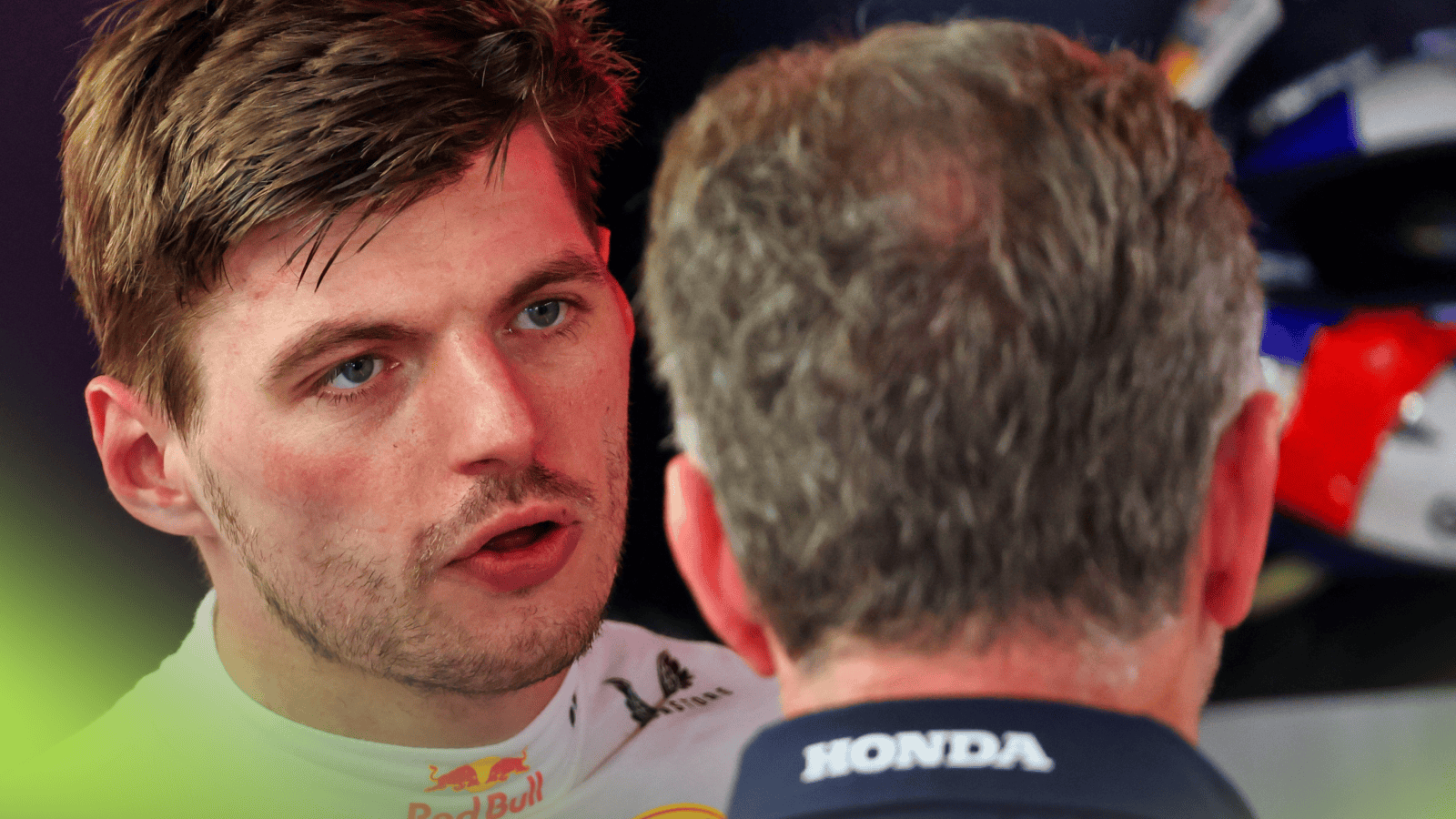 Max Verstappen in a tense conversation with a Red Bull colleague